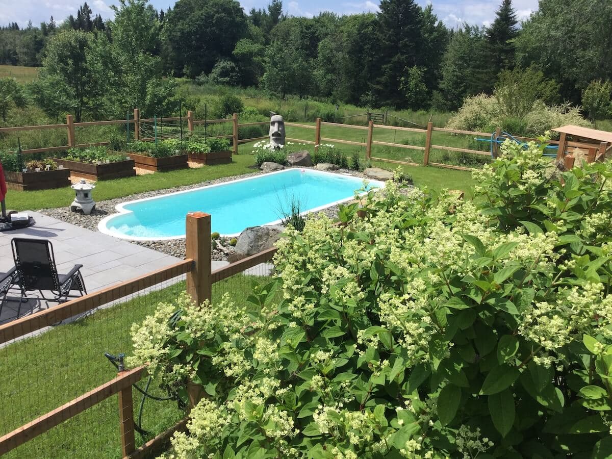 Family enjoying a fiberglass pool at sunset