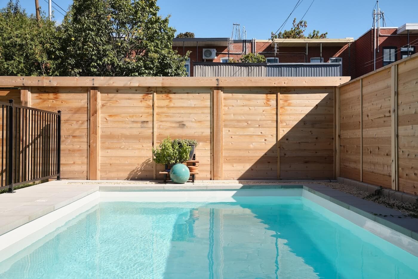 SK Pool installer working beside a fiberglass pool